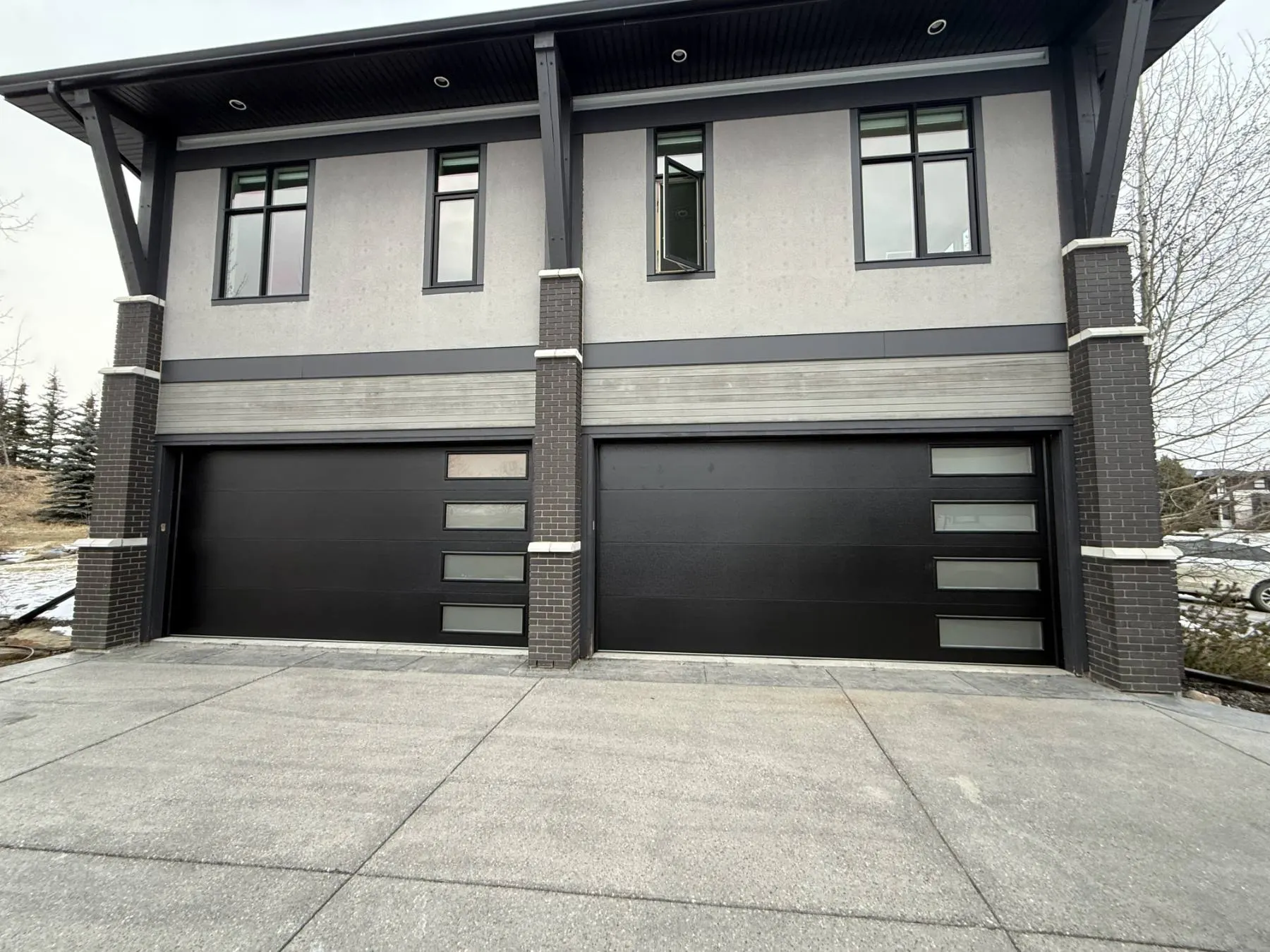 Two black garage doors with frosted glass, installed by Eagle Garage Doors